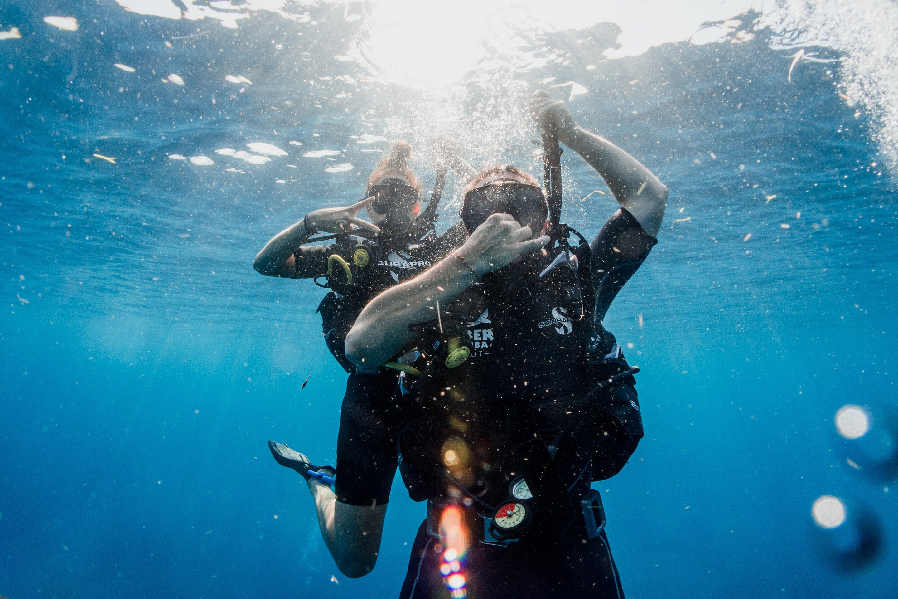 Two divers descending underwater