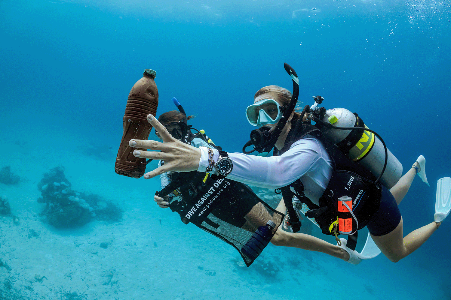 Two divers cleaning up the ocean.
